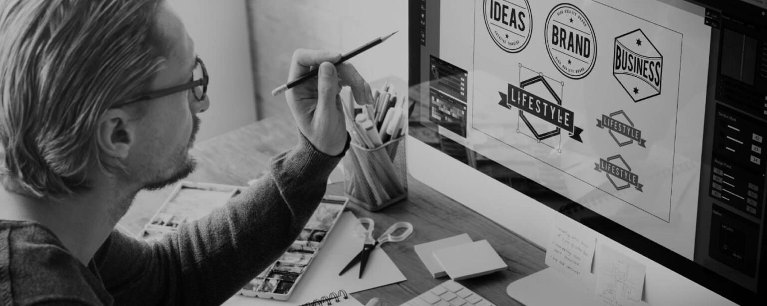 A man is working in front of a computer