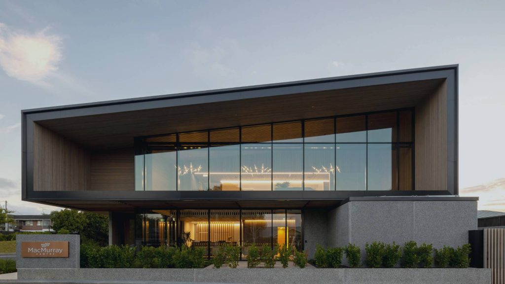 Modern home with glass wall and door.